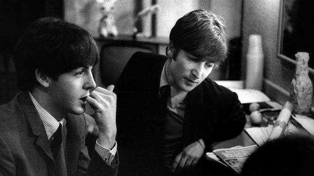 LONDON - 30th DECEMBER: Paul McCartney and John Lennon (1940-1980) from The Beatles posed backstage at the Finsbury Park Astoria, London during the band's Christmas Show residency on 30th December 1963.  (Photo by Val Wilmer/Redferns)