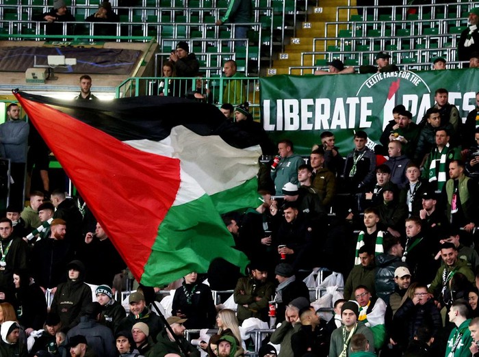 Soccer Football - Champions League - Group E - Celtic v Atletico Madrid - Celtic Park, Glasgow, Scotland, Britain - October 25, 2023 A Celtic fan waves a Palestinian flag in support of Palestine amid the ongoing conflict between Israel and the Palestinian Islamist group Hamas before the match REUTERS/Russell Cheyne