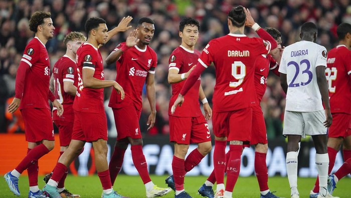 Liverpool players celebrate after Liverpools Wataru Endo, centre, scored his sides second goal during the Europa League Group E soccer match between Liverpool and Toulouse, at Anfield in Liverpool, England, Thursday, Oct. 26, 2023. (AP Photo/Jon Super)