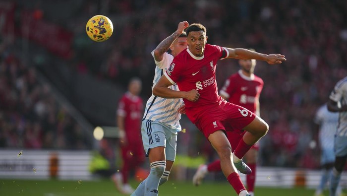 Nottingham Forests Nicolas Dominguez, left, challenges for the ball with Liverpools Trent Alexander-Arnold during the English Premier League soccer match between Liverpool and Nottingham Forest, at Anfield in Liverpool, England, Sunday, Oct. 29, 2023. (AP Photo/Jon Super)