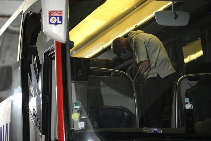 Police take finger prints in a bus that the Lyon soccer team were traveling in, before arriving at the Velodrome Stadium prior to the French League One soccer match between Olympique de Marseille and Lyon in Marseille, France, Sunday, Oct. 29, 2023. Lyon coach Fabio Grosso has suffered a head injury as the team bus came under attack from fans throwing projectiles before the French league soccer game against Marseille. (AP Photo/Daniel Cole)