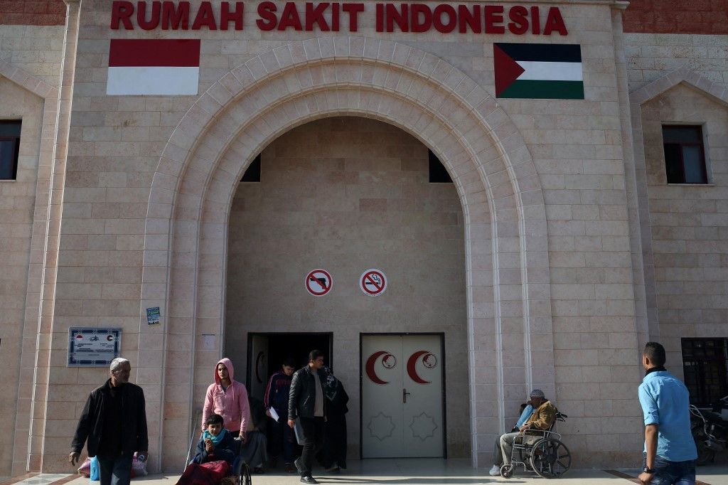 Palestinians stand outside the Indonesian Hospital in Beit Lahia in the northern Gaza Strip on January 13, 2016. The Indonesian Hospital, which is the first new hospital in a decade in the Palestinian enclave, was funded by an Indonesian NGO and opened its doors at the end of 2015.The 50-day war in July-August 2014, which killed 73 Israelis and some 2,200 Palestinians, destroyed or severely damaged more than 20,000 Palestinian homes, 148 schools, 15 hospitals and 45 primary healthcare centres. (Photo by MOHAMMED ABED / AFP)