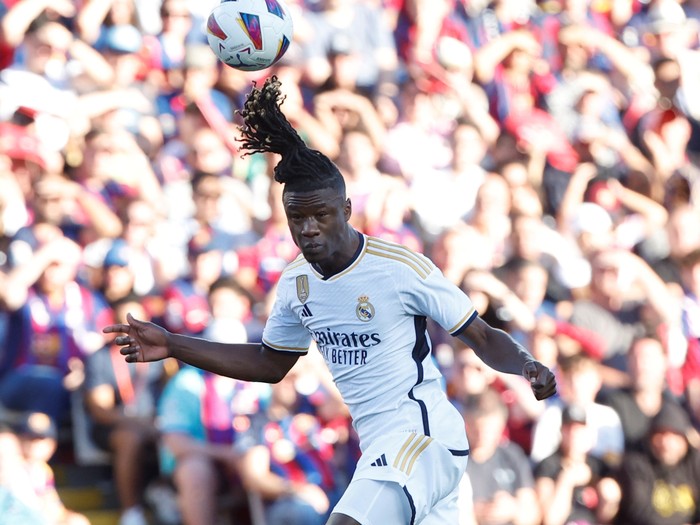 Real Madrids Eduardo Camavinga heads the ball ahead of Barcelonas Joao Cancelo during the La Liga soccer match between Barcelona and Real Madrid at the Olympic Stadium in Barcelona, Spain, Saturday, Oct. 28, 2023. (AP Photo/Joan Monfort)