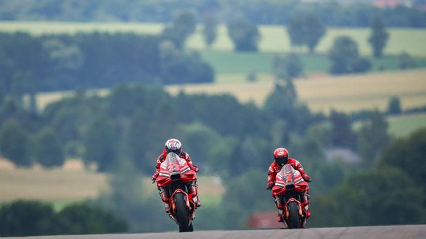 Ducati Lenovo Team's Italian rider Enea Bastianini (L) and Ducati Lenovo Team's Italian rider Francesco Bagnaia steer their motorbikes during the first free practice for the MotoGP German motorcycle Grand Prix at the Sachsenring racing circuit in Hohenstein-Ernstthal near Chemnitz, eastern Germany, on June 16, 2023. (Photo by Ronny Hartmann / AFP)