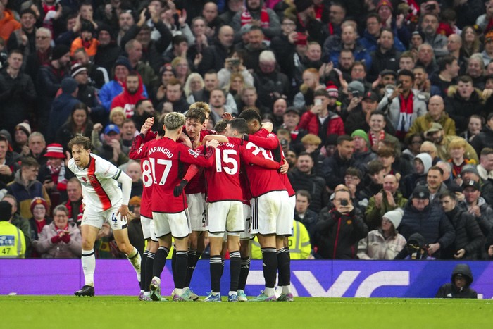 Manchester United players celebrate after Manchester Uniteds Victor Lindelof scored his sides opening goal during the English Premier League soccer match between Manchester United and Luton Town at the Old Trafford stadium in Manchester, England, Saturday, Nov. 11, 2023. (AP Photo/Jon Super)