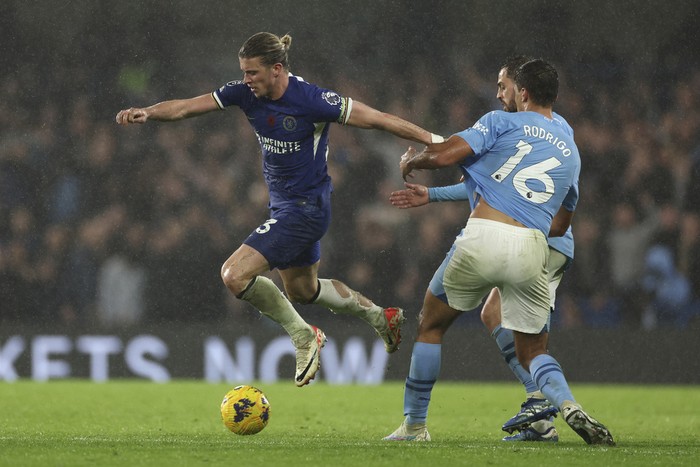 Chelseas Conor Gallagher, left, challenges for the ball with Manchester Citys Rodrigo during the English Premier League soccer match between Chelsea and Manchester City at Stamford Bridge stadium in London, Sunday, Nov. 12, 2023. (AP Photo/Ian Walton)