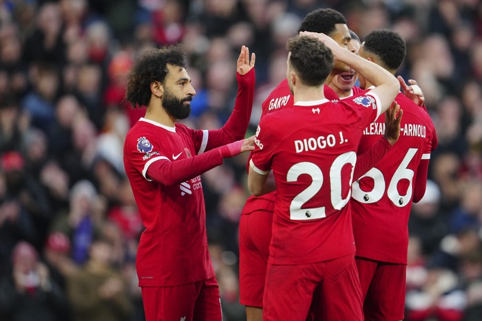 Liverpools Mohamed Salah is congratulated after scoring his sides opening goal during the English Premier League soccer match between Liverpool and Brentford at Anfield stadium in Liverpool, England, Sunday, Nov. 12, 2023. (AP Photo/Jon Super)