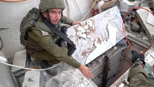 Israeli military spokesperson Rear Admiral Daniel Hagari shows what the Israeli military says is a tunnel at a location given as Gaza, in this still image taken from video released November 13, 2023. Israel Defense Forces/Handout via REUTERS Acquire Licensing Rights