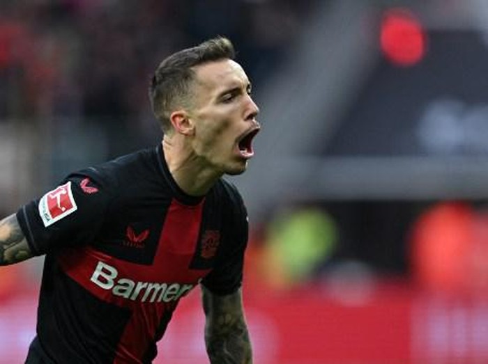 Bayer Leverkusen's Spanish defender #20 Alejandro Grimaldo celebrates scoring his team's first goal during the German first division Bundesliga football match Bayer 04 Leverkusen v 1 FC Union Berlin in Leverkusen, western Germany on November 12, 2023. (Photo by INA FASSBENDER / AFP) / DFL REGULATIONS PROHIBIT ANY USE OF PHOTOGRAPHS AS IMAGE SEQUENCES AND/OR QUASI-VIDEO
