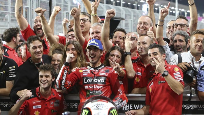 Second placed, Ducati rider Francesco Bagnaia, of Italy, center, celebrates with his teammates end of the Qatari MotoGP Grand Prix at the Lusail International Circuit in Lusail, Qatar, Sunday, Nov. 19, 2023. (AP Photo/Hussein Sayed)
