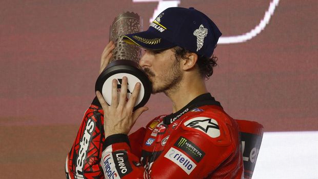 Ducati Lenovo Team's Italian rider Francesco Bagnaia poses on the podium with his second place trophy after the Moto GP Grand Prix of Qatar at the Lusail International Circuit, in the city of Lusail on November 19, 2023. (Photo by KARIM JAAFAR / AFP)