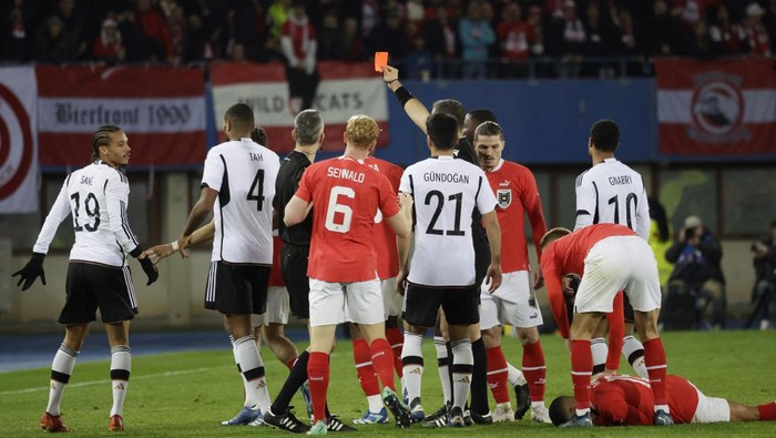 Soccer Football - International Friendly - Austria v Germany - Ernst Happel Stadium, Vienna, Austria - November 21, 2023 Germany's Leroy Sane is shown a red card by referee Slavko Vincic REUTERS/Leonhard Foeger