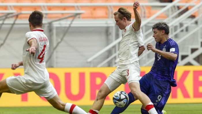 Argentinas Agustin Ruberto (R) and Polands Jakub Krzyzanowski (C) fight for the ball during the 2023 FIFA U-17 World Cup Indonesia qualification football match between Poland and Argentina at Jakarta International Stadium in Jakarta on November 17, 2023. (Photo by BAY ISMOYO / AFP)