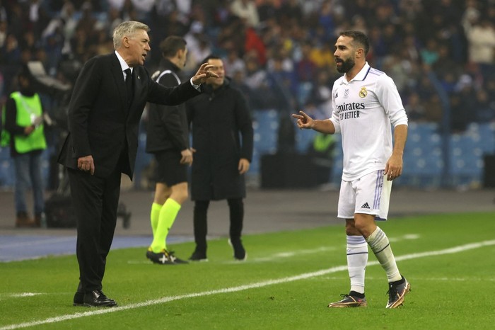 Real Madrids Italian coach Carlo Ancelotti (L) talks with Real Madrids Spanish defender Dani Carvajal during the Spanish Super Cup final football match between Real Madrid CF and FC Barcelona at the King Fahd International Stadium in Riyadh, Saudi Arabia, on January 15, 2023. (Photo by Fayez NURELDINE / AFP)