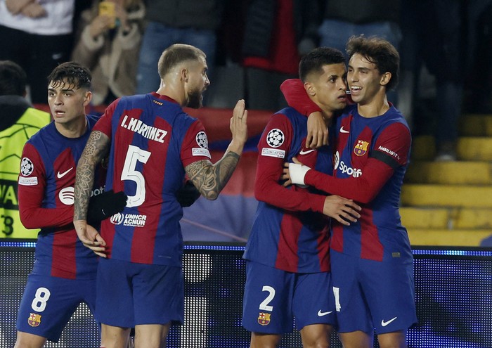 Barcelona Soccer Football - Champions League - Group H - FC Barcelona v FC Porto - Estadi Olimpic Lluis Companys, Barcelona, Spain - November 28, 2023 FC Barcelona's Joao Cancelo scores their first goal with FC Barcelona's Joao Felix REUTERS/Albert Gea