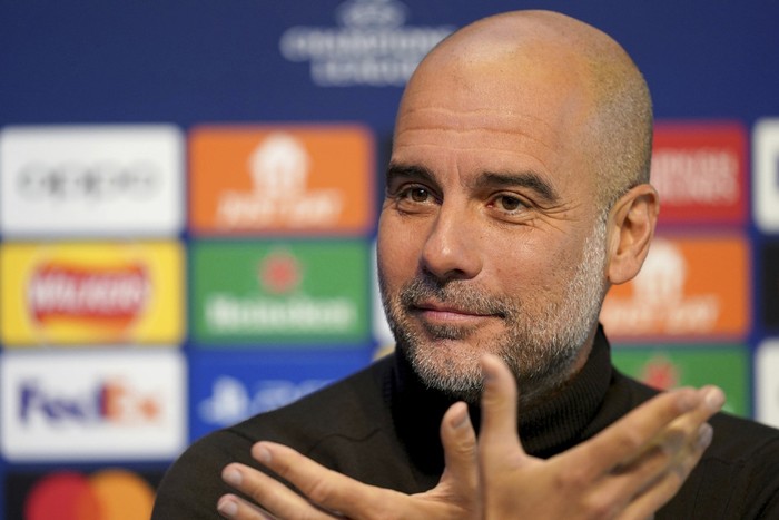 Manchester City manager Pep Guardiola reacts during a press conference at the City Football Academy in Manchester, England, Monday Nov. 27, 2023, ahead of their Champions League match vs Leipzig. (Martin Rickett/PA via AP)