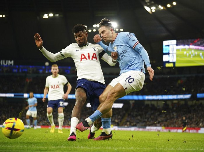 Manchester Citys Jack Grealish, right, attempts a shot at goal in front of Tottenhams Emerson Royal during the English Premier League soccer match between Manchester City and Tottenham Hotspur at the Etihad Stadium in Manchester, England, Thursday, Jan. 19, 2023. (AP Photo/Dave Thompson)