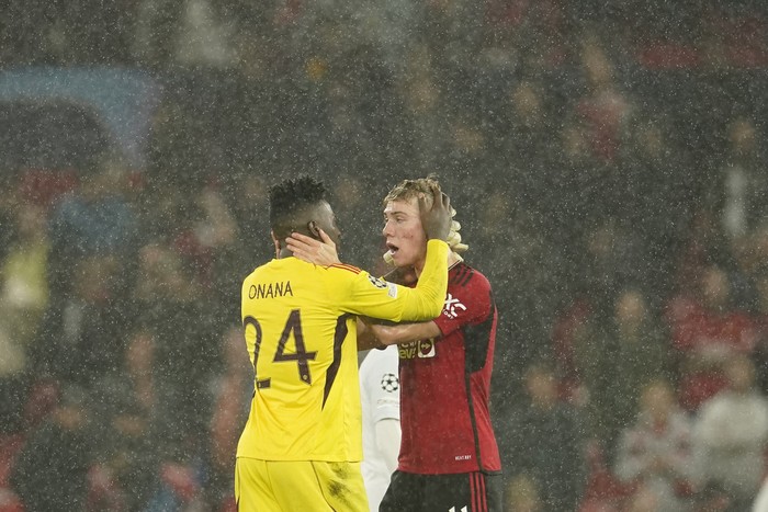 Manchester Uniteds goalkeeper Andre Onana, left, reacts with his teammate Rasmus Hojlund during the Champions League group A soccer match between Manchester United and Galatasaray at the Old Trafford stadium in Manchester, England, Tuesday, Oct. 3, 2023. (AP Photo/Dave Thompson)