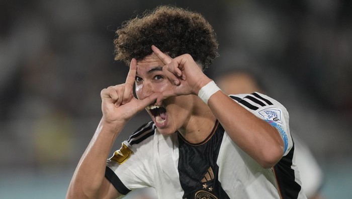 Germanys Noah Darvich celebrates after scoring his teams second goal during the U-17 World Cup final soccer match between Germany and France at Manahan Stadium in Surakarta, Indonesia, Saturday, Dec. 2, 2023. (AP Photo/Achmad Ibrahim)