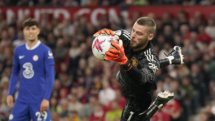 Manchester Uniteds goalkeeper David de Gea makes a save during the English Premier League soccer match between Manchester United and Chelsea at the Old Trafford stadium in Manchester, England, Thursday, May 25, 2023. (AP Photo/Dave Thompson)