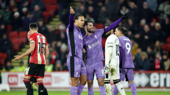 SHEFFIELD, ENGLAND - DECEMBER 06: Dominik Szoboszlai of Liverpool celebrates with Virgil van Dijk of Liverpool after scoring his teams second goal during the Premier League match between Sheffield United and Liverpool FC at Bramall Lane on December 06, 2023 in Sheffield, England. (Photo by David Rogers/Getty Images)