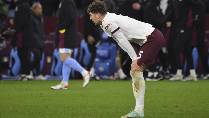 Manchester Citys John Stones pauses. On the pitch at the end of the English Premier League soccer match between Aston Villa and Manchester City at Villa Park in Birmingham, England, Wednesday, Dec. 6, 2023. (AP Photo/Rui Vieira)