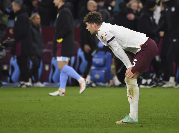 Manchester Citys John Stones pauses. On the pitch at the end of the English Premier League soccer match between Aston Villa and Manchester City at Villa Park in Birmingham, England, Wednesday, Dec. 6, 2023. (AP Photo/Rui Vieira)