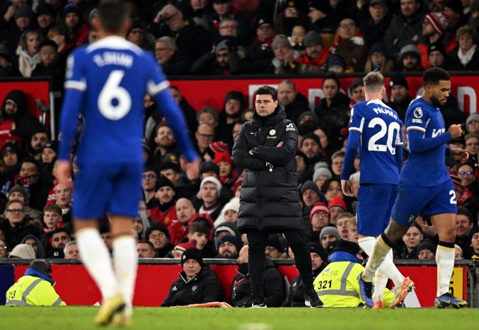 Chelseas Argentinian head coach Mauricio Pochettino watches the players from the touchline during the English Premier League football match between Manchester United and Chelsea at Old Trafford in Manchester, north west England, on December 6, 2023. (Photo by Oli SCARFF / AFP) / RESTRICTED TO EDITORIAL USE. No use with unauthorized audio, video, data, fixture lists, club/league logos or live services. Online in-match use limited to 120 images. An additional 40 images may be used in extra time. No video emulation. Social media in-match use limited to 120 images. An additional 40 images may be used in extra time. No use in betting publications, games or single club/league/player publications. /