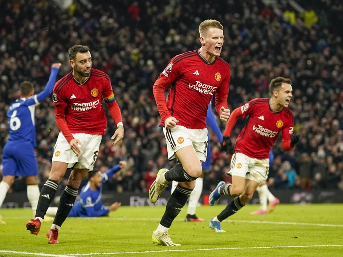 Manchester Uniteds Scott McTominay, center, celebrates after scoring his sides second goal during the English Premier League soccer match between Manchester United and Chelsea at Old Trafford stadium in Manchester, England, Wednesday, Dec. 6, 2023. (AP Photo/Dave Thompson)