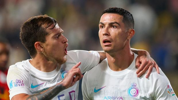 Nassr's Portuguese forward #07 Cristiano Ronaldo (R) celebrates his goal with Nassr's Portuguese midfielder #25 Otavio (L) during the Saudi Pro League football match between Al-Nassr and Al-Riyadh at al-Awwal Park Stadium in Riyadh on December 8, 2023. (Photo by Fayez NURELDINE / AFP)