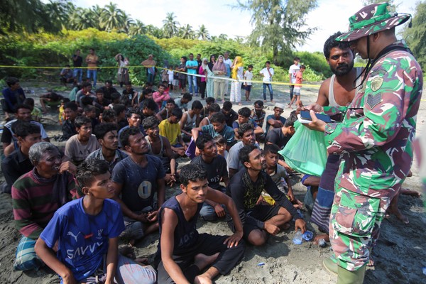 Rohingya Muslims rest on a beach after they land in Blang Raya, Pidie, Aceh province, Indonesia, December 10, 2023. REUTERS/Stringer NO RESALES. NO ARCHIVES