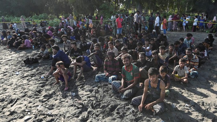 Rohingya Muslims rest on a beach after they land in Blang Raya, Pidie, Aceh province, Indonesia, December 10, 2023. REUTERS/Stringer NO RESALES. NO ARCHIVES