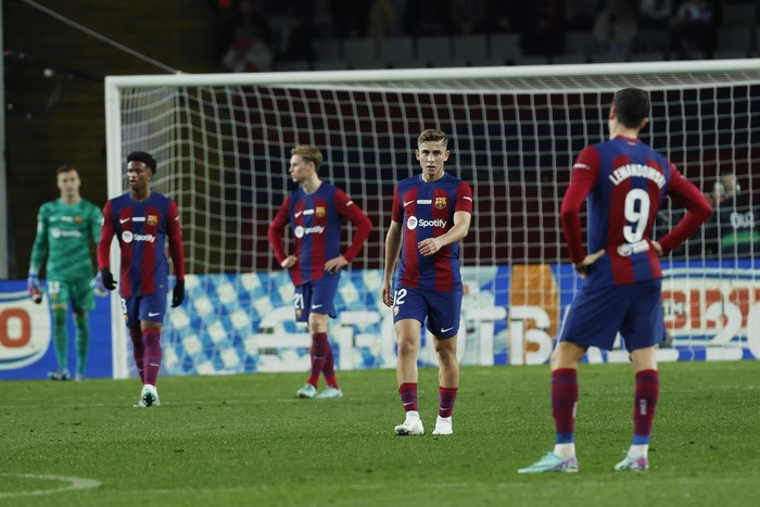 Barcelona's team players react after the Spanish La Liga soccer match between Barcelona and Girona at the Olimpic Lluis Companys stadium in Barcelona, Spain, Sunday, Dec. 10, 2023. (AP Photo/Joan Monfort)