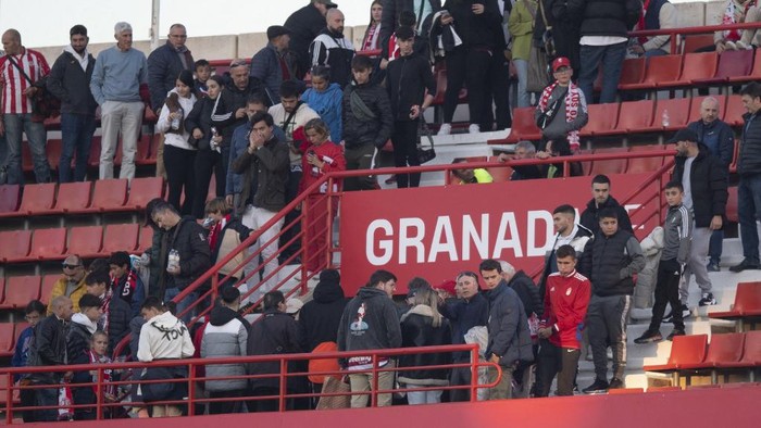 Supporters leave as the match is being suspended due to a medical issue in the tribunes, during the Spanish league football match between Granada FC and Athletic Club Bilbao at Los Carmenes stadium in Granada on December 10, 2023. (Photo by JORGE GUERRERO / AFP)