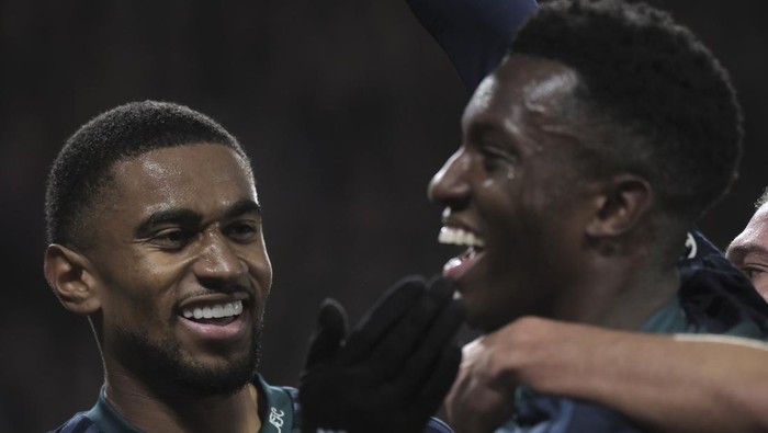 Arsenals Eddie Nketiah, right, is congratulated by teammate Reiss Nelson after scoring a goal, during the Champions League, Group B soccer match between PSV Eindhoven and Arsenal, at Philips stadium in Eindhoven, Netherlands, Tuesday, Dec. 12, 2023. (AP Photo/Patrick Post)