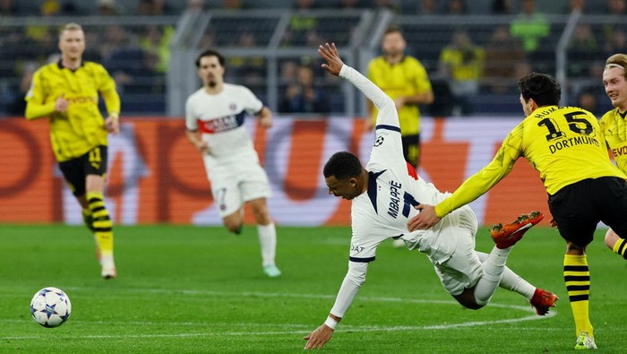 Soccer Football - Champions League - Group F - Borussia Dortmund v Paris St Germain - Signal Iduna Park, Dortmund, Germany - December 13, 2023 Paris St Germains Kylian Mbappe in action with Borussia Dortmunds Mats Hummels REUTERS/Wolfgang Rattay