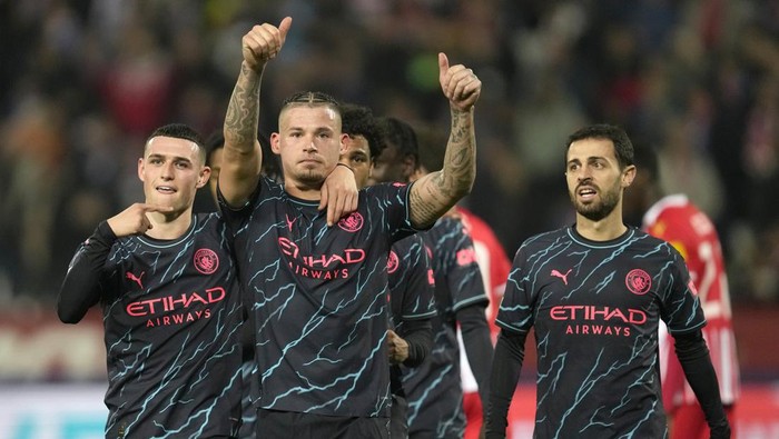 Manchester Citys Kalvin Phillips, centre, celebrates after scoring his sides third goal during the Group G Champions League soccer match between Red Star and Manchester City, at the Rajko Mitic Stadium in Belgrade, Serbia, Wednesday, Dec. 13, 2023. (AP Photo/Darko Vojinovic)
