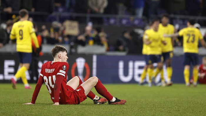 Liverpools Conor Bradley lies on the ground at the end of the Europa League Group E soccer match between Union SG and Liverpool at the RSC Anderlecht stadium in Brussels, Thursday, Dec. 14, 2023. (AP Photo/Geert Vanden Wijngaert)
