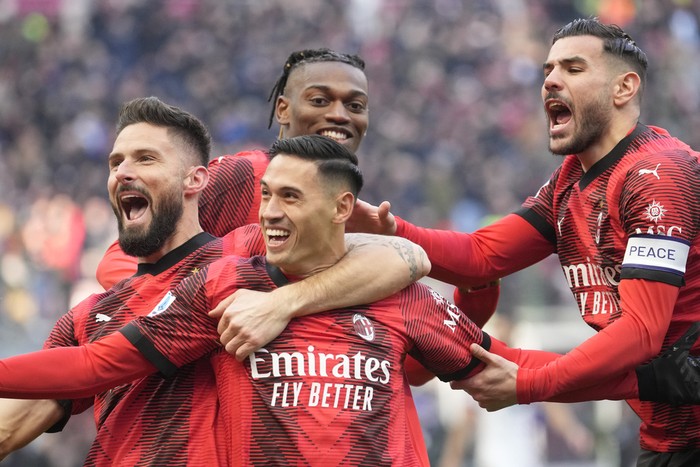 AC Milans Tijjani Reijnders, centre, celebrates after scoring his sides opening goal during a Serie A soccer match between AC Milan and Monza, at the San Siro stadium in Milan, Italy, Sunday, Dec. 17, 2023. (AP Photo/Luca Bruno)