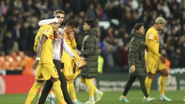 Barcelonas Raphinha, left, reacts after the Spanish La Liga soccer match between Valencia and Barcelona at the Mestalla stadium in Valencia, Spain, Saturday, Dec. 16, 2023. (AP Photo/Alberto Saiz)