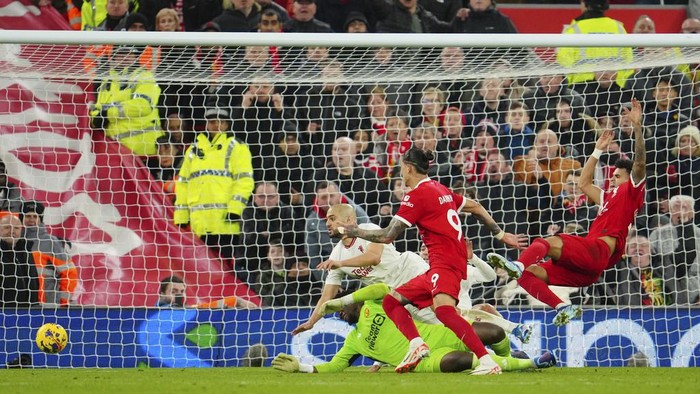 Liverpools Luis Diaz, right, and Darwin Nunez, centre, challenge for the ball with Manchester Uniteds Sofyan Amrabat, left, and goalkeeper Andre Onana during the English Premier League soccer match between Liverpool and Manchester United at the Anfield stadium in Liverpool, England, Sunday, Dec.17, 2023. (AP Photo/Jon Super)