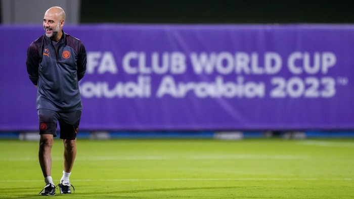 Manchester Citys head coach Pep Guardiola laughs during a training session at the King Abdullah Sports City Stadium in Jeddah, Saudi Arabia, Monday, Dec. 18, 2023. Urawa Reds will play against Manchester City during the semifinal soccer match during the Club World Cup on Tuesday Dec. 19.(AP Photo/Manu Fernandez)