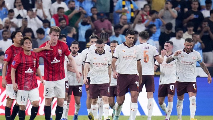 Manchester City players celebrate after Urawa Reds Marius Hoibraten, 3rd left, scored an own goal to open the score during the Soccer Club World Cup semifinal soccer match between Urawa Reds and Manchester City FC at King Abdullah Sports City Stadium in Jeddah, Saudi Arabia, Tuesday, Dec. 19, 2023. (AP Photo/Manu Fernandez)