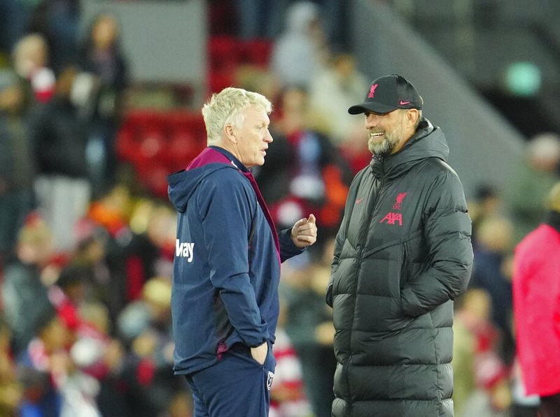 Liverpool's manager Jurgen Klopp, right, and West Ham's manager David Moyes speak before the English Premier League soccer match between Liverpool and West Ham United at Anfield stadium in Liverpool, England, Wednesday, Oct. 19, 2022. (AP Photo/Jon Super)