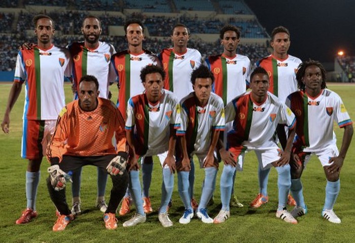 Eritrea national football team players line up for a team photo just before the start of the FIFA World cup qualifying match at Francistowns Stadium on October 13, 2015. Ten footballers from Eritreas national squad have sought political asylum in Botswana after playing in a qualifying match for the 2018 World Cup, an Eritrean non-governmental organisation said October 16. The players were part of the national team -- known as the Red Sea Camels -- that lost 3-1 to Botswana in Francistown on October 13.  AFP PHOTO / MONIRUL BHUIYAN (Photo by Monirul Bhuiyan / AFP)