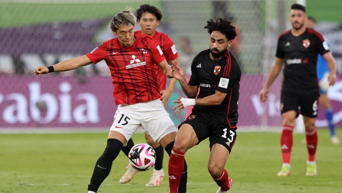 Soccer Football - Club World Cup - Third Place Playoff - Urawa Red Diamonds v Al-Ahly - Prince Abdullah Al Faisal Stadium, Jeddah, Saudi Arabia - December 22, 2023 Urawa Red Diamonds Takahiro Akimoto in action with Al Ahlys Marwan Ateya REUTERS/Ahmed Yosri
