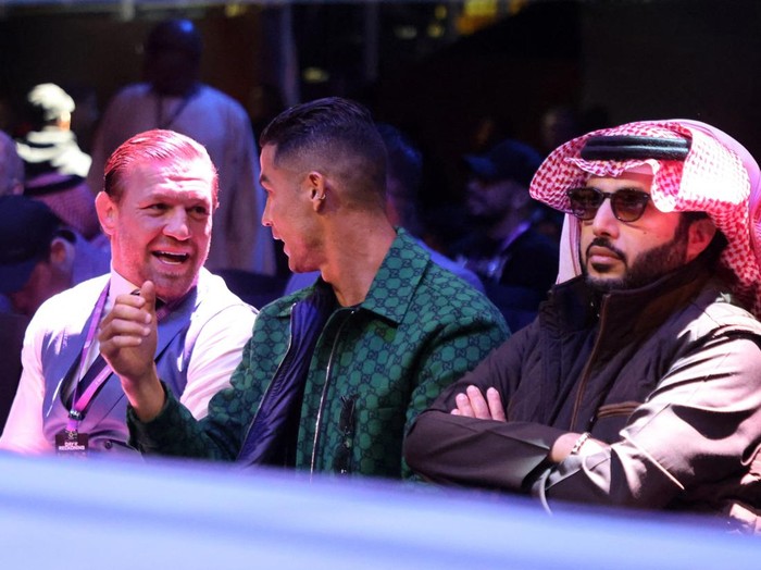 Boxing - Anthony Joshua v Otto Wallin - Kingdom Arena, Riyadh, Saudi Arabia - December 23, 2023 Conor McGregor, Cristiano Ronaldo and Turki Alalshikh are seen in the stands before the fight REUTERS/Ahmed Yosri