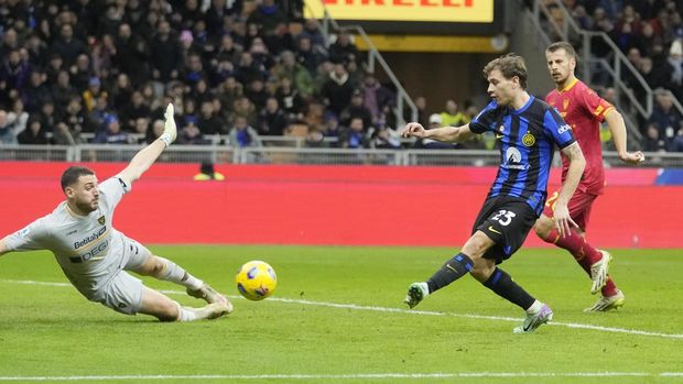 Inter Milan's Nicolo Barella, centre, scores his side's second goal past Lecce's goalkeeper Wladimiro Falcone during the Serie A soccer match between Inter Milan and Lecce at the San Siro stadium in Milan, Italy, Saturday, Dec. 23, 2023. (AP Photo/Luca Bruno)