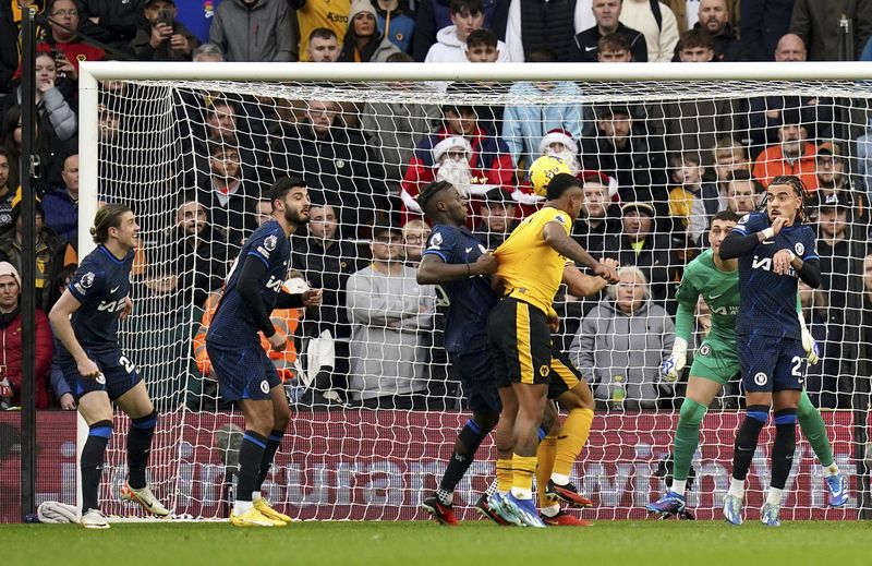 Wolverhampton Wanderers' Mario Lemina, 3rd from right, scores his side's first goal during the English Premier League soccer match between Wolverhampton Wanderers and Chelsea at Molineux stadium in Wolverhampton, England, Sunday, Dec. 24, 2023. (Jacob King/PA via AP)
