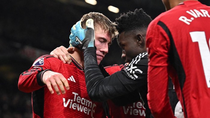 Manchester Uniteds Danish striker #11 Rasmus Hojlund (L) celebrates with Manchester Uniteds Cameroonian goalkeeper #24 Andre Onana (R) after scoring their third goal during the English Premier League football match between Manchester United and Aston Villa at Old Trafford in Manchester, north west England, on December 26, 2023. (Photo by Oli SCARFF / AFP) / RESTRICTED TO EDITORIAL USE. No use with unauthorized audio, video, data, fixture lists, club/league logos or live services. Online in-match use limited to 120 images. An additional 40 images may be used in extra time. No video emulation. Social media in-match use limited to 120 images. An additional 40 images may be used in extra time. No use in betting publications, games or single club/league/player publications. /